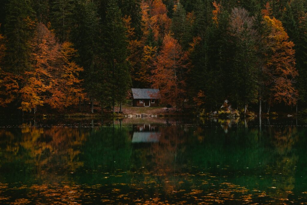 Lake home among autumn trees