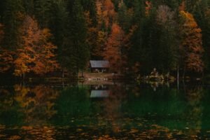 Lake home among autumn trees